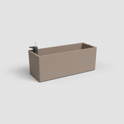 Rectangular beige planter with a black faucet on a light gray background