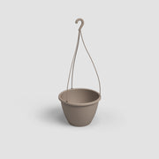 Brown hanging plant pot on a light gray background