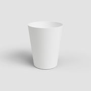 White ceramic planter on a light gray background