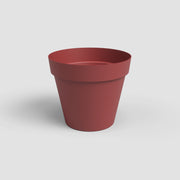 Red flower pot on a light gray background