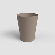 Beige plastic cup on a white background