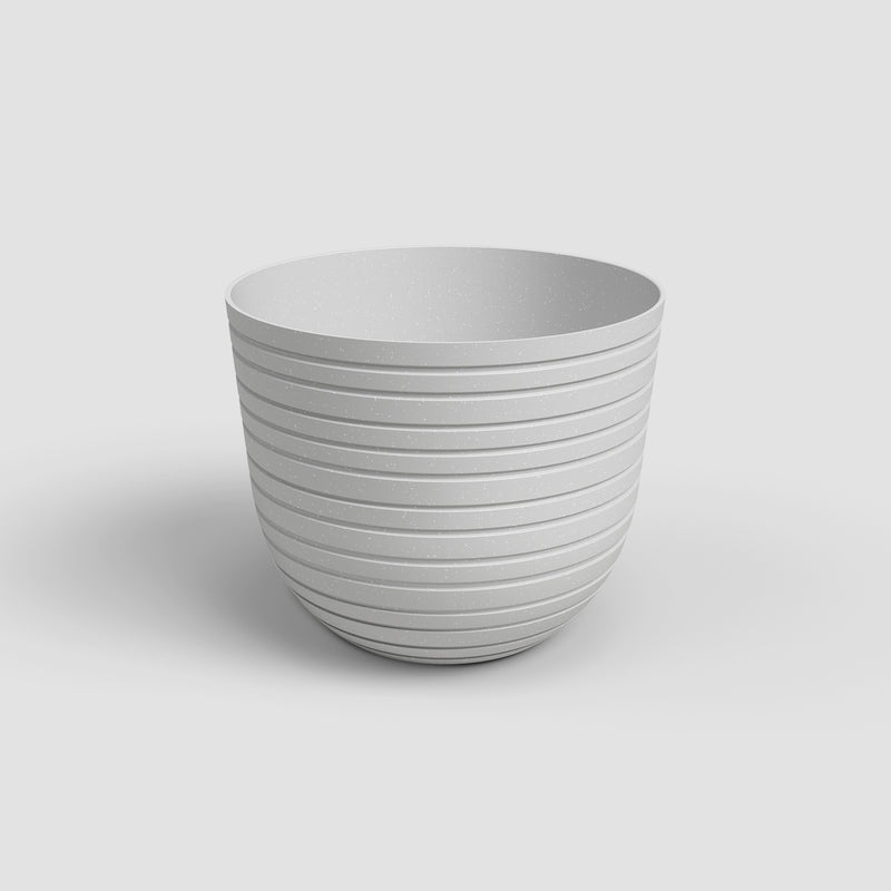 White ceramic planter with ribbed texture on a light gray background