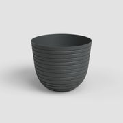 Dark gray ribbed pot on a light gray background