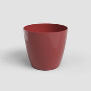 Red ceramic cup on a white background