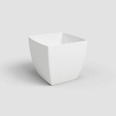 White ceramic planter on a light gray background