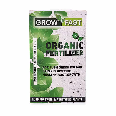 Box of Grow Fast Organic Fertilizer with green leaves on a white background