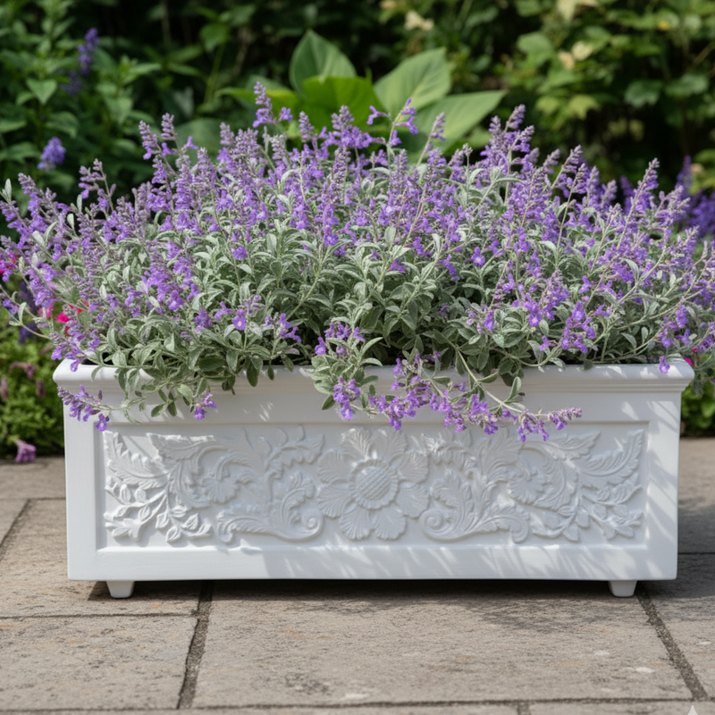 Decorative white planter with purple flowers on a stone patio