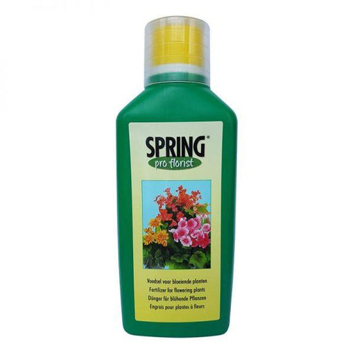 Green bottle of Spring Pro-Florist fertilizer with a yellow cap on a white background